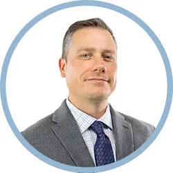 Rob Kennedy, a professional headshot showing the Swept Dating founder and CEO smiling warmly at the camera, wearing business attire against a neutral background